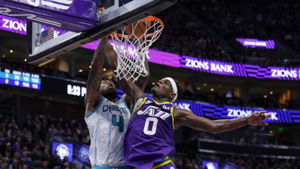 Feb 22, 2024; Salt Lake City, Utah, USA; Charlotte Hornets center Nick Richards (4) dunks the ball over Utah Jazz forward Taylor Hendricks (0) during the second half at Delta Center.